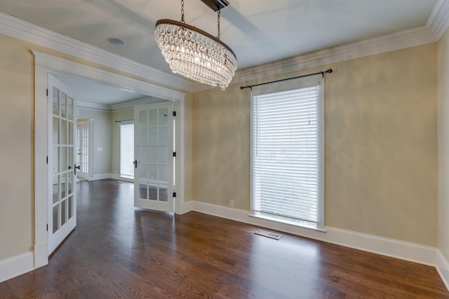 unfurnished room with dark hardwood / wood-style flooring, ornamental molding, an inviting chandelier, and french doors