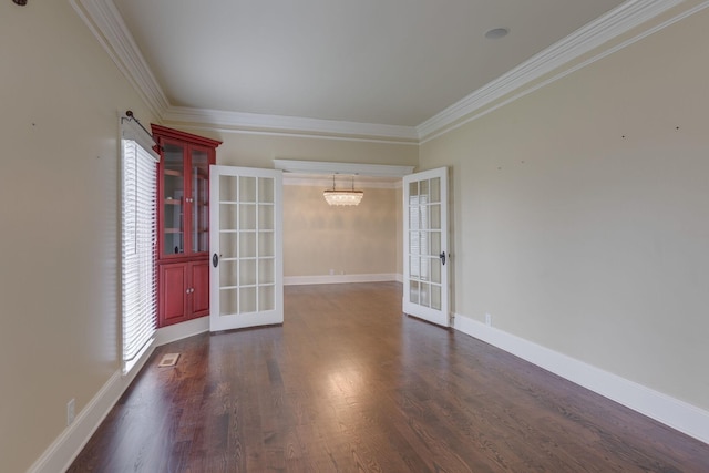 unfurnished room featuring ornamental molding, dark hardwood / wood-style floors, and french doors