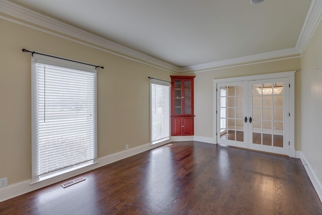 empty room with crown molding, dark hardwood / wood-style floors, and french doors