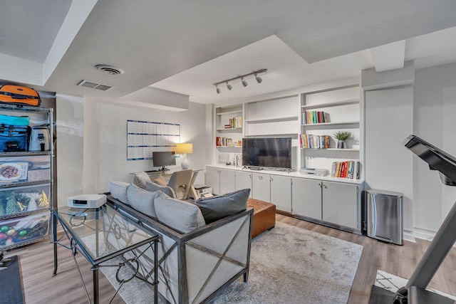 living room featuring light hardwood / wood-style floors and rail lighting