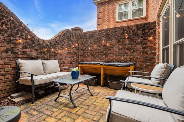 view of patio / terrace featuring an outdoor living space and a hot tub