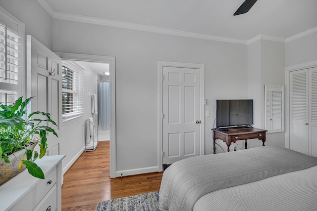 bedroom with ornamental molding and light hardwood / wood-style floors