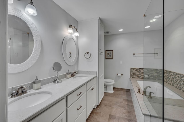 bathroom featuring vanity, a bathtub, and toilet