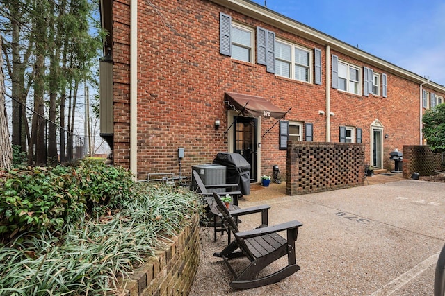 rear view of house featuring central air condition unit and a patio area