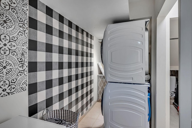 washroom with light tile patterned flooring and stacked washer and clothes dryer