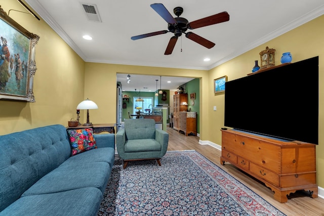 living room with crown molding, hardwood / wood-style flooring, and ceiling fan