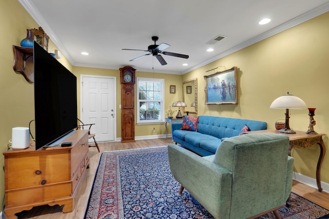 living room featuring crown molding, ceiling fan, and light hardwood / wood-style floors