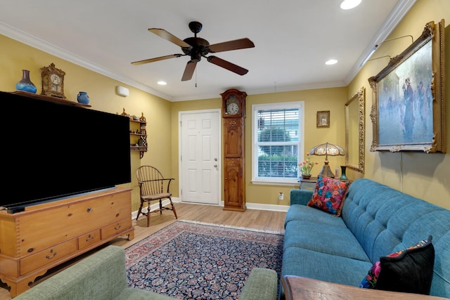 living room featuring crown molding, wood-type flooring, and ceiling fan