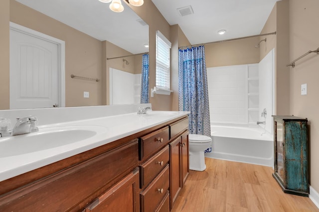 full bathroom with wood-type flooring, toilet, shower / tub combo, and vanity