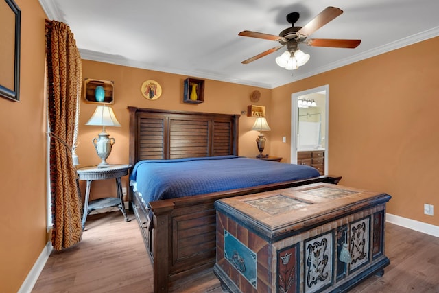 bedroom featuring connected bathroom, crown molding, wood-type flooring, and ceiling fan