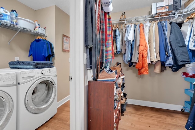 laundry room featuring hardwood / wood-style floors and washer and dryer