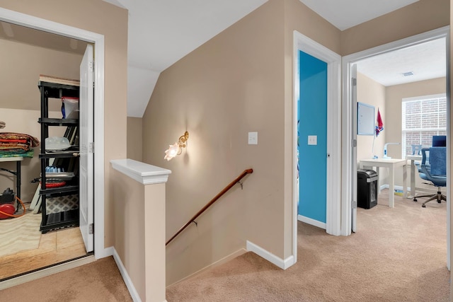 hallway with light colored carpet