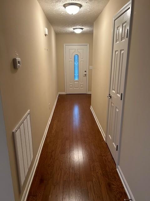 entryway featuring dark hardwood / wood-style floors and a textured ceiling