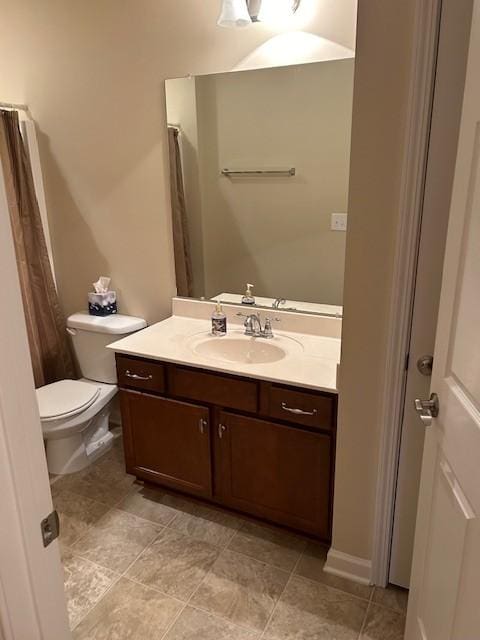 bathroom featuring tile patterned flooring, vanity, and toilet