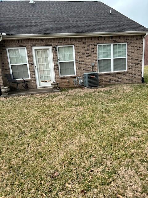 exterior space featuring a patio, cooling unit, and a lawn