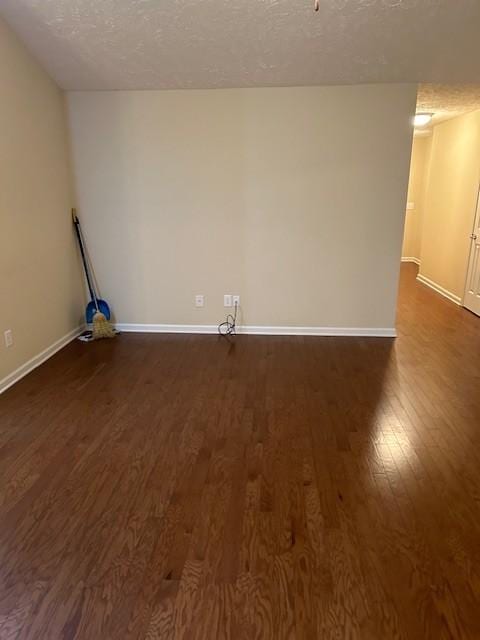 laundry room featuring dark hardwood / wood-style floors and a textured ceiling