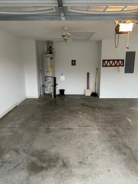 garage with electric panel and water heater