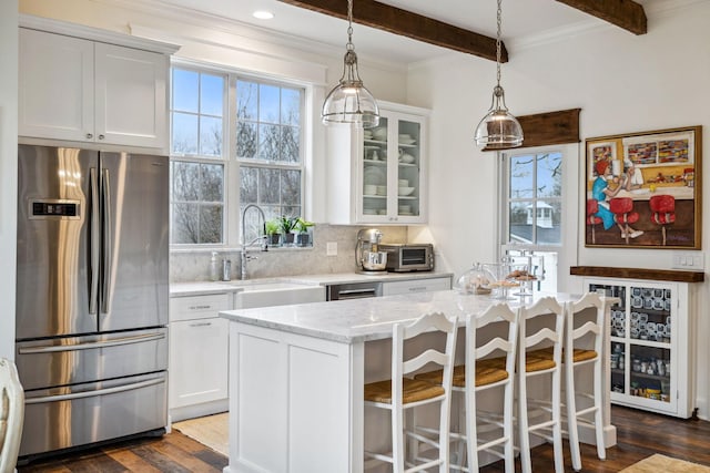 2111 Hoovers Rd, Duck River, TN 38454 - kitchen with light stone counters, stainless steel refrigerator, a kitchen island, decorative backsplash, and white cabinets