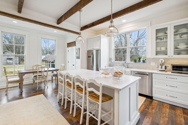2111 Hoovers Rd, Duck River, TN 38454 - kitchen featuring a kitchen bar, white cabinetry, a center island, hanging light fixtures, and appliances with stainless steel finishes