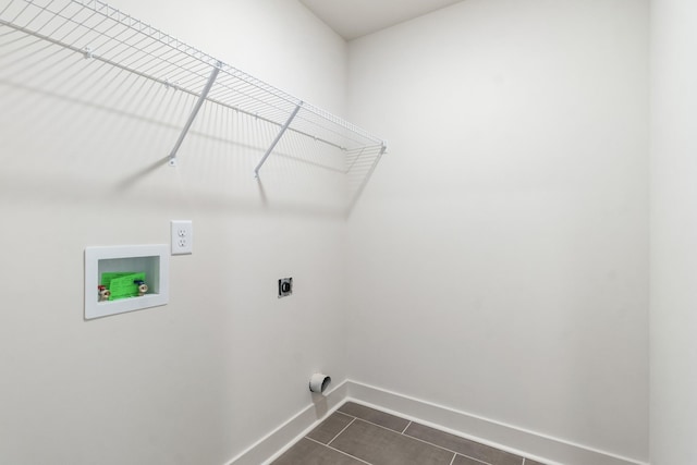 laundry area with electric dryer hookup, washer hookup, and dark tile patterned flooring