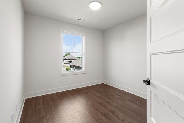 spare room with dark hardwood / wood-style floors