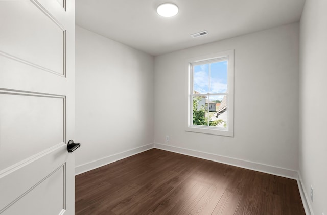 spare room featuring dark hardwood / wood-style flooring