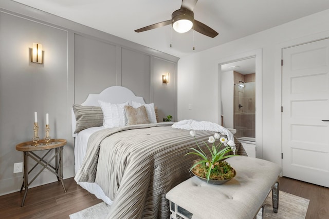 bedroom with ceiling fan, connected bathroom, and dark hardwood / wood-style flooring