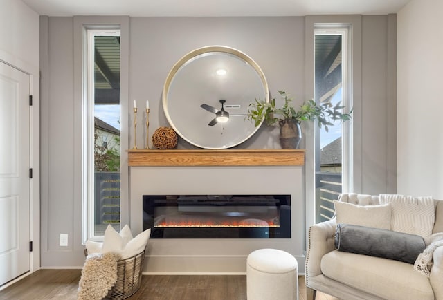 sitting room with wood-type flooring and ceiling fan