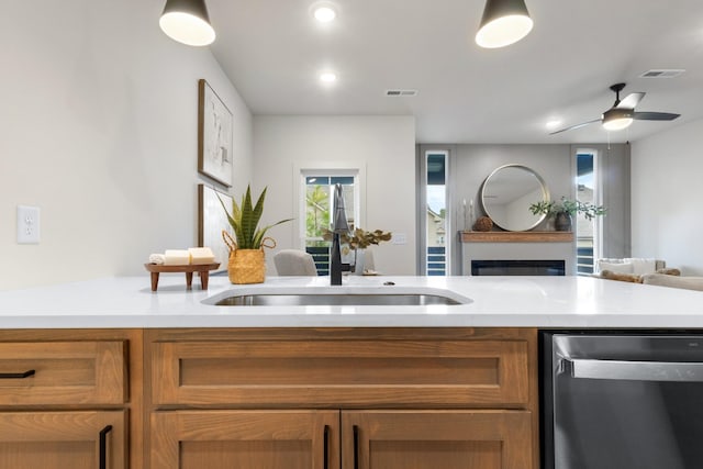 kitchen with sink, stainless steel dishwasher, and ceiling fan