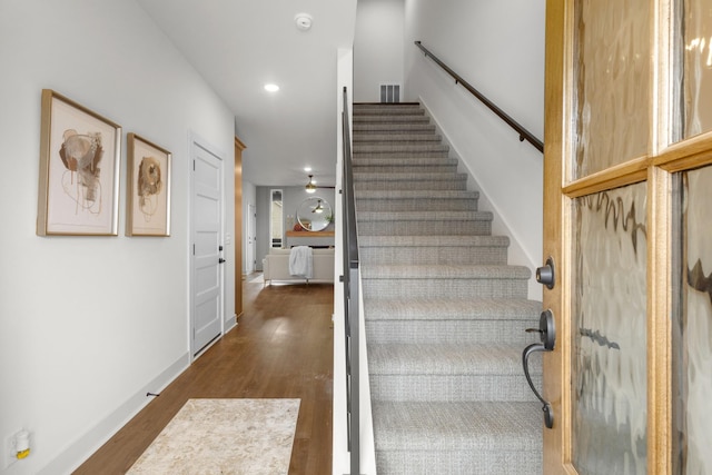 stairway featuring hardwood / wood-style floors