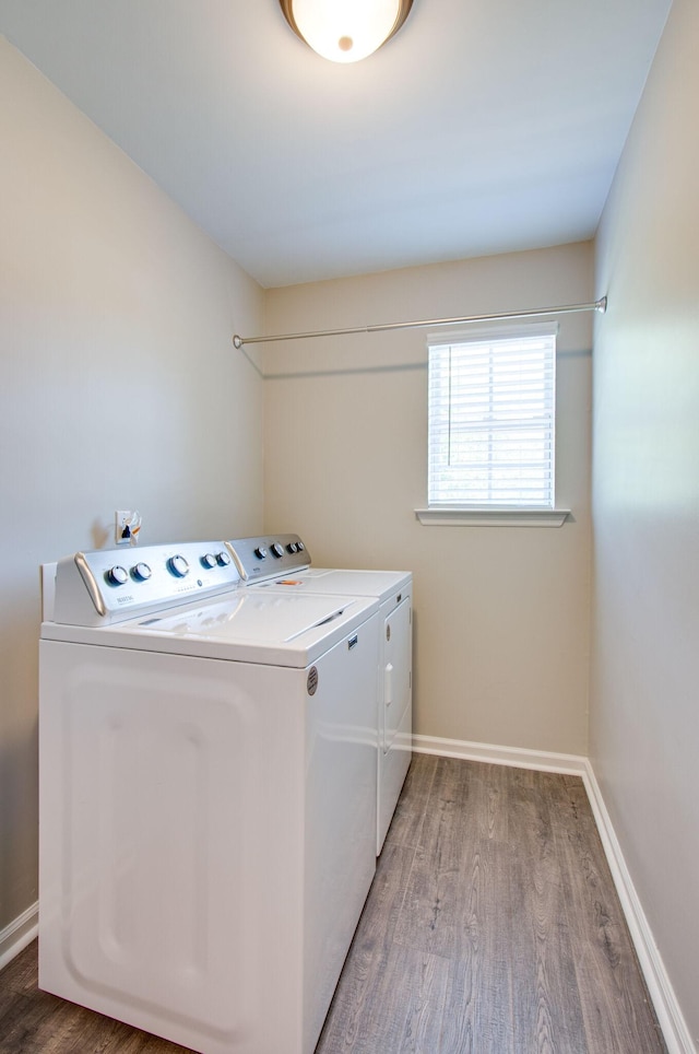 washroom featuring wood-type flooring and washing machine and dryer