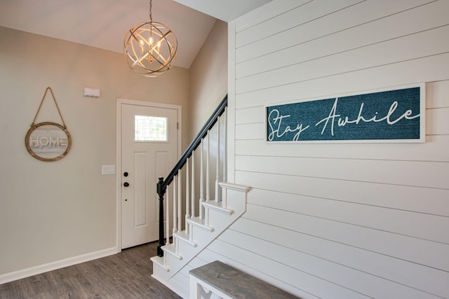 foyer entrance featuring hardwood / wood-style floors and a chandelier