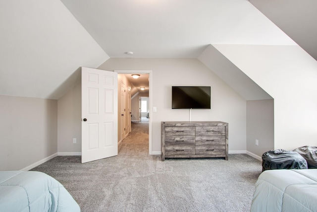 bedroom featuring light carpet and vaulted ceiling