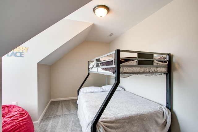 bedroom featuring carpet and lofted ceiling