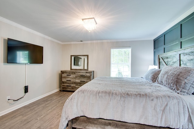 bedroom with crown molding and light hardwood / wood-style flooring