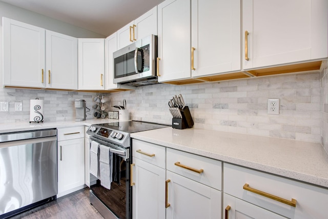 kitchen featuring tasteful backsplash, appliances with stainless steel finishes, and white cabinets