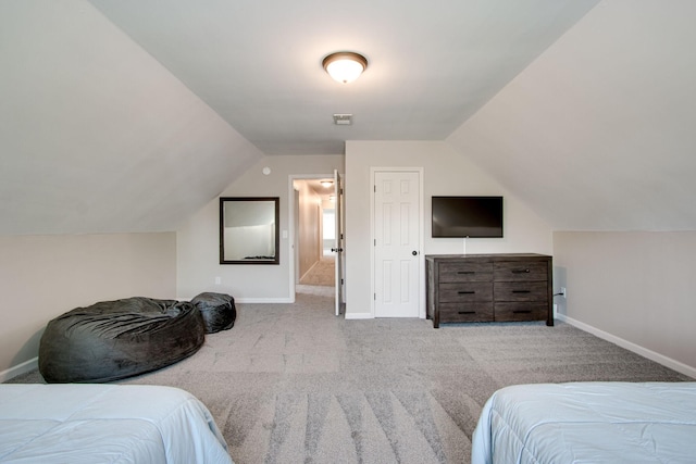 carpeted bedroom with lofted ceiling