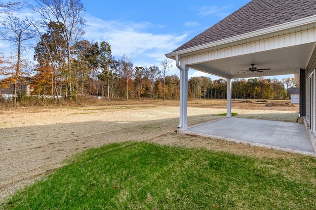 view of yard with ceiling fan and a patio area