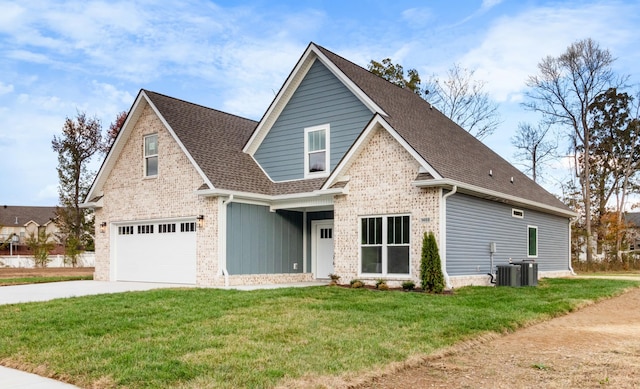 view of front of property featuring a garage, central AC, and a front yard