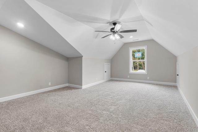 additional living space with vaulted ceiling, carpet flooring, and ceiling fan