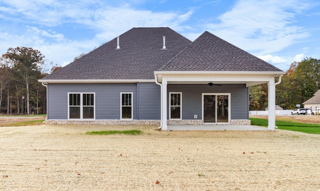 rear view of property with ceiling fan and a patio area