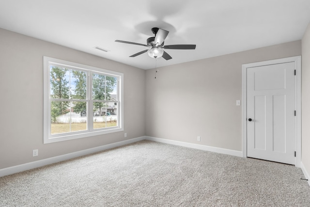 spare room with ceiling fan and carpet floors