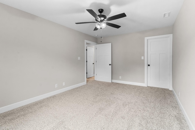 carpeted spare room with ceiling fan