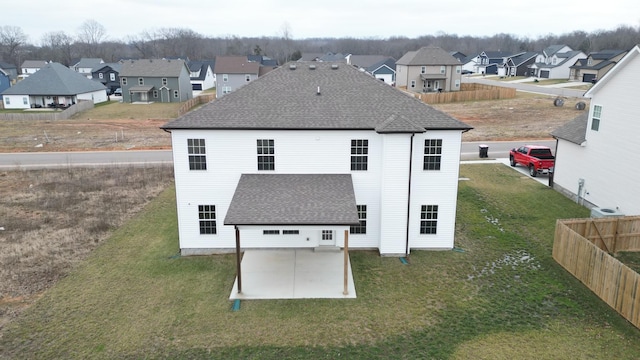 rear view of house featuring a patio and a lawn