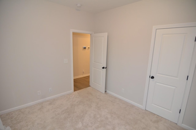 spare room with light colored carpet