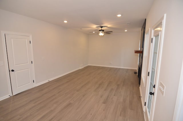 unfurnished living room featuring hardwood / wood-style floors and ceiling fan