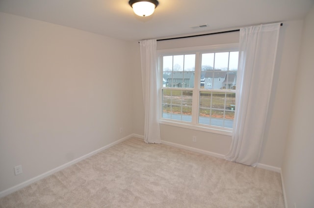 spare room with light colored carpet