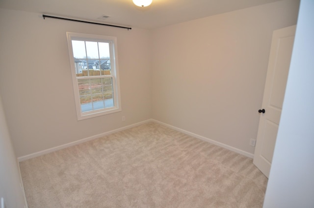 spare room with light colored carpet