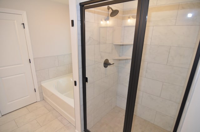 bathroom featuring shower with separate bathtub