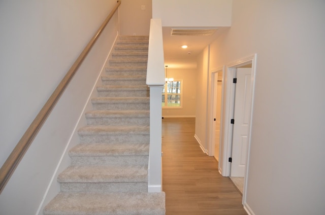 stairs featuring hardwood / wood-style flooring